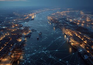 Aerial view of an illuminated harbour at night, with digital lines representing networking.